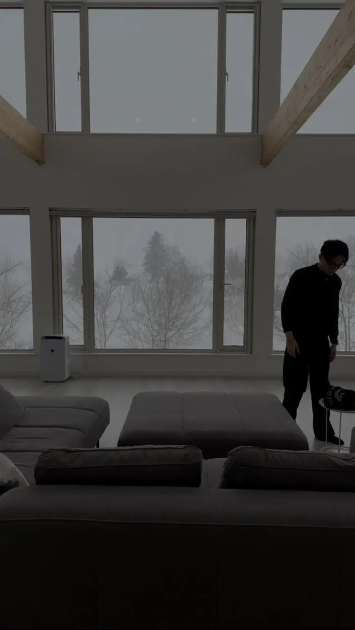 Vatana Pang at a ski chalet window in Niseko